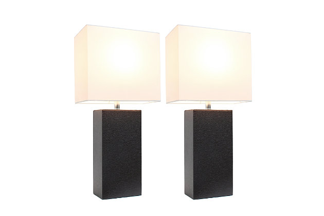 These fashionable table lamps, with their genuine leather bodies and white fabric shades, will add style and pizzazz to any room. We believe that lighting is like jewelry for your home. Our products will help to enhance your room with elegance and sophistication.Set includes 2  lamp bases and 2 shades | Leather wrapped base | White fabric shades | Assembled dimensions: l: 10" x w: 6" x h: 21"