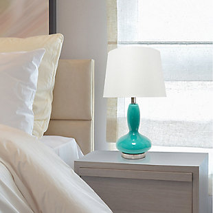 A beautiful lighting solution versatile enough for any room in your home, this contemporary lamp features a teal glass base topped with a white fabric shade.  Simplicity and style at its best!   Perfect for your living room, bedroom, office, or anywhere you need to add a tasteful update!Fabric white shade | The base is made of teal glass | 1 x 60w medium type a base bulb (not included) required | More base color options available!