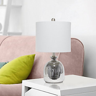 With a textured glass base and gray fabric drum shade, this lamp is sure to update any room in your home with a little charm.  This lovely lamp is crafted with an open bottom glass base in a silver metallic color. Perfect for adding the little refresh to your living room, bedroom, foyer or office that you've been looking for!Fabric gray shade | Metallic silver glass base | 1 x 60w medium type a base bulb (not included) required | More shade color options available!
