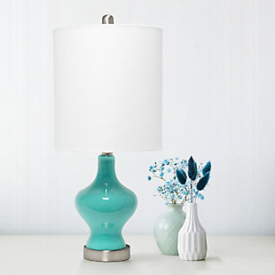 Simple and elegant, this lamp is sure to make a tasteful update to any room in your home.  This lamp features a beautifully shaped teal glass base complimented by a white fabric drum shade. Rejuvenate your living room, bedroom, foyer or office with this trendy lamp!Fabric white shade | Beautifully shaped teal glass base | 1 x 60w medium type a base bulb (not included) required | More base color options available!