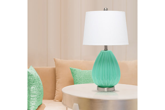 Illuminate your space with this chic and charming table lamp.  The seafoam glass base is curvy and accentuated with a pleated design topped off with a white fabric shade.   Perfect for your living room, bedroom, office, or anywhere you need to add a tasteful update!Fabric white shade | Pleated seafoam glass base | 1 x 60w medium type a base bulb (not included) required | More base color options available!