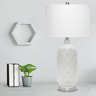This simple yet sophisticated lamp stands tall at 29.25" and is sure to make a statement in any room in your home.  The crisp white glass is delicately designed with a charming pattern and complimented with brushed nickel accents and a fresh white fabric drum shade.   Perfect for large foyers, bedrooms, living rooms or offices!Fabric white shade | The white glass base is adorned with a beautiful, sophisticated design | 1 x 100w 3-way medium type a base bulb (not included) required | 5 foot clear cord