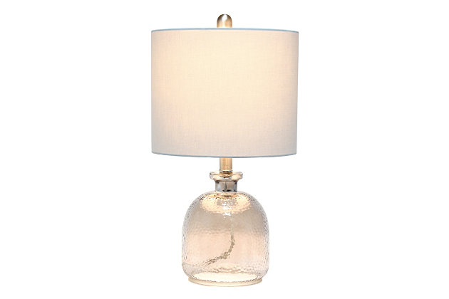 With a textured glass base and gray fabric drum shade, this lamp is sure to update any room in your home with a little charm.  This lovely lamp is crafted with an open bottom glass base in a transparent gray color. Perfect for adding the little refresh to your living room, bedroom, foyer or office that you've been looking for!Fabric gray shade | Transparent gray glass base | 1 x 60w medium type a base bulb (not included) required | More shade color options available!
