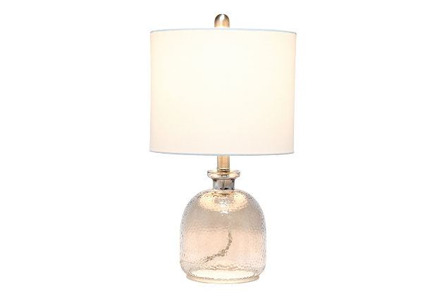 With a textured glass base and white fabric drum shade, this lamp is sure to update any room in your home with a little charm.  This lovely lamp is crafted with an open bottom glass base in a transparent gray color. Perfect for adding the little refresh to your living room, bedroom, foyer or office that you've been looking for!Fabric white shade | Transparent gray glass base | 1 x 60w medium type a base bulb (not included) required | More shade color options available!