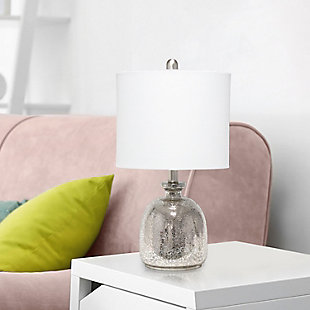With a textured glass base and white fabric drum shade, this lamp is sure to update any room in your home with a little charm.  This lovely lamp is crafted with an open bottom glass base in mercury. Perfect for adding the little refresh to your living room, bedroom, foyer or office that you've been looking for!Fabric white shade | Mercury glass base | 1 x 60w medium type a base bulb (not included) required | More shade base color options available!