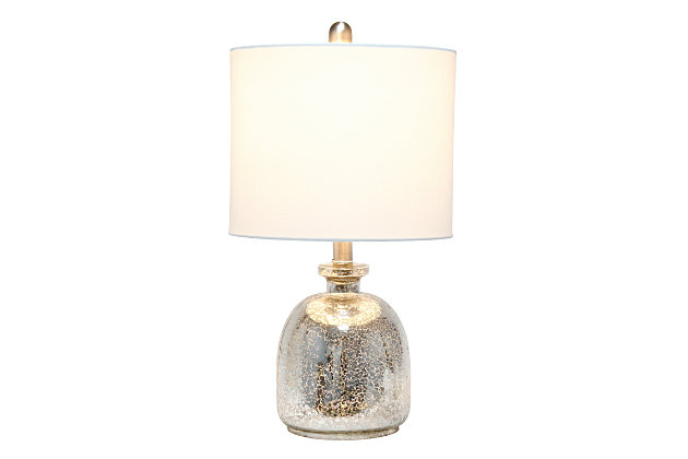 With a textured glass base and white fabric drum shade, this lamp is sure to update any room in your home with a little charm.  This lovely lamp is crafted with an open bottom glass base in mercury. Perfect for adding the little refresh to your living room, bedroom, foyer or office that you've been looking for!Fabric white shade | Mercury glass base | 1 x 60w medium type a base bulb (not included) required | More shade base color options available!