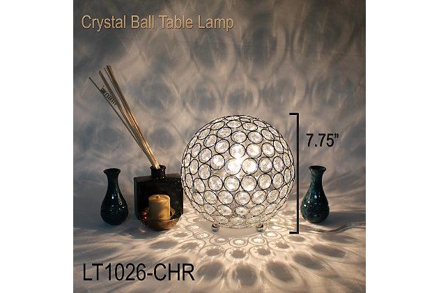 Make your room sparkle with a shining ball of crystals. The perfect addition to any bedroom, office, nursery, or even a foyer or entryway! We believe that lighting is like jewelry for your home. Our products will help to enhance your room with elegance and sophistication.Crystal ball shape glows from within casting pretty shadows | Threaded with steel rings and set on ball feet | Chrome plated finish | Height: 8" diameter: 7.75"