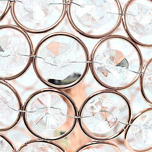 Make your room sparkle with a shining ball of crystals. The perfect addition to any bedroom, office, nursery, or even a foyer or entryway! We believe that lighting is like jewelry for your home. Our products will help to enhance your room with elegance and sophistication.Crystal ball shape glows from within casting pretty shadows | Threaded with steel rings and set on ball feet | Rose gold finish | Height: 8" diameter: 7.75"