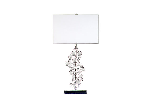 Bejewel your home with this exquisite sequin table lamp. It features beautiful prismatic crystals, a soft white colored shade, and a flawless chrome finish. We believe that lighting is like jewelry for your home. Our products will help to enhance your room with elegance and sophistication.Beautiful prismatic crystals | Soft white fabric shade | Flawless chrome finish | Total height: 26.25"  shade : l: 14' x w: 9"