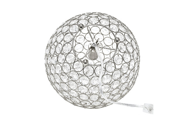 Make your room sparkle with a beautifully designed crystal ball shaped lamp. This 10" version is available in one of the many available finishes is the perfect addition to any bedroom, office, nursery, or even a foyer or entryway! We believe that lighting is like jewelry for your home. Our products will help to enhance your room with elegance and sophistication.Crystal ball shape glows from within casting pretty shadows | Threaded with steel rings and set on ball feet | Chrome finish | Height: 10" diameter:10"