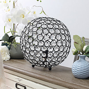 Make your room sparkle with a beautifully designed crystal ball shaped lamp. This 10" version is available in one of the many available finishes is the perfect addition to any bedroom, office, nursery, or even a foyer or entryway! We believe that lighting is like jewelry for your home. Our products will help to enhance your room with elegance and sophistication.Crystal ball shape glows from within casting pretty shadows | Threaded with steel rings and set on ball feet | Restoration bronze finish | Height: 10" diameter:10"