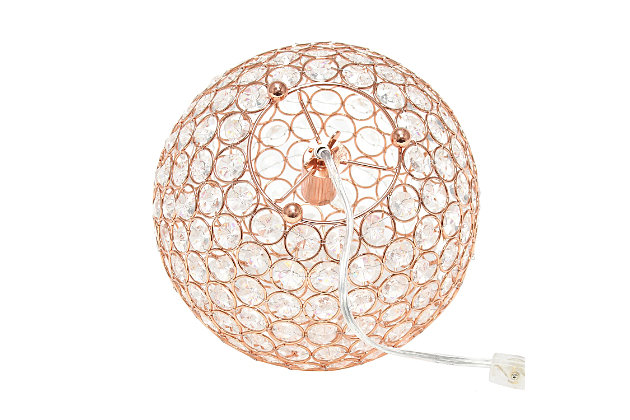 Make your room sparkle with a beautifully designed crystal ball shaped lamp. This 10" version is available in one of the many available finishes is the perfect addition to any bedroom, office, nursery, or even a foyer or entryway! We believe that lighting is like jewelry for your home. Our products will help to enhance your room with elegance and sophistication.Crystal ball shape glows from within casting pretty shadows | Threaded with steel rings and set on ball feet | Rose gold finish | Height: 10" diameter:10"
