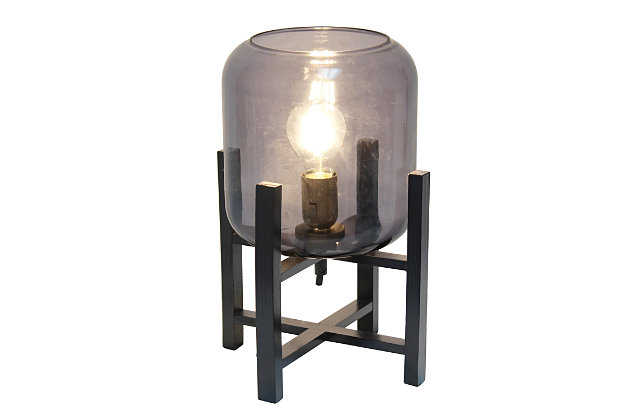 This contemporary lamp elevates the glass shade on a four-arm wood stand finished in black.  The curvy cylindrical smokey glass shade combined with the geometric wood base creates the perfect ensemble.  Place on a desk, nightstand, dresser or table  for a modest, refined look in fashion lighting.
**HELPFUL TIP: To get the complete vintage look, we recommend using a decorative Edison/Vintage bulb (not included). **Black wood base | Smokey glass shade | Easily accessible on/off switch located on the cord | Uses 1 x 40w medium type a base bulb (not included).
For full vintage look, type t45 edison bulb is recommended