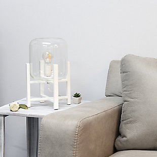 This contemporary lamp elevates the glass shade on a four-arm wood stand finished in white.  The curvy cylindrical clear glass shade combined with the geometric wood base creates the perfect ensemble.  Place on a desk, nightstand, dresser or table  for a modest, refined look in fashion lighting.
**HELPFUL TIP: To get the complete vintage look, we recommend using a decorative Edison/Vintage bulb (not included). **White wood base | Clear glass shade | Easily accessible on/off switch located on the cord | Uses 1 x 40w medium type a base bulb (not included).
For full vintage look, type t45 edison bulb is recommended