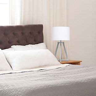 Add a touch of simplicity to your home with this contemporary lamp. The soft, white fabric shade compliments the geometric gray wood base for a clean, simple look. Perfect lamp for a bedroom, living area, office, kid's room or college dorm.Gray wood base | White fabric shade | Easily accessible on/off switch located on the cord | Uses 1 x 40w type a base bulb (not included)