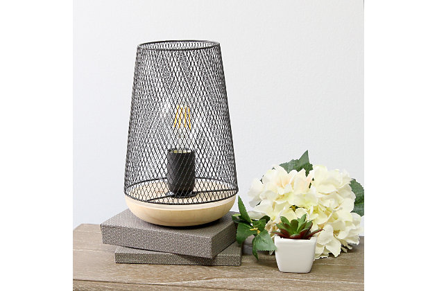 This metal table lamp with mesh shade will add ambiance and style to any room in your home! With a simple, lattice cut out design and natural wood base this lamp illuminates beautiy. Undoubtedly the perfect accent piece to your home, this industrial lamp will not disappoint! **HELPFUL TIP: To get the complete vintage look, we recommend using a decorative Edison/Vintage bulb (not included). **Natural wood base | Black mesh metal shade | Easily accessible on/off switch located on the cord | Uses 1 x 40w type a base bulb (not included) for vintage look, type t45 edison bulb is recommended