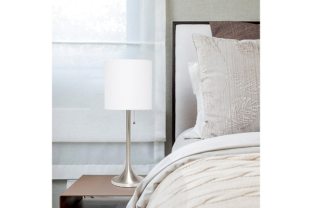 This fun and fashionable lamp features a brushed nickel metal base and white fabric drum shade making it the perfect addition to your lighting needs. This lamp will add simplicity and style to any space in your home.  Perfect for bedrooms, kids and teens, college dorms, nurseries, or fun offices!Brushed nickel metal base | White fabric shade | Pull chain on/off switch | Uses 1 x 40w medium type a base bulb (not included)