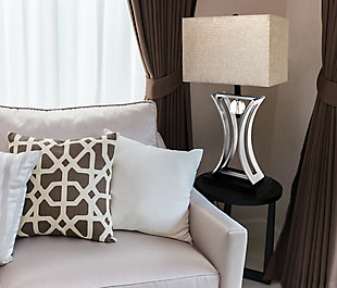 This modern table lamp features an hourglass shape and pendulum design. The chrome finished body, matte black base, and commercial beige and gray rectangular shade complement this current look. This lamp will add a contemporary flair to any conference room, waiting area, or office. We believe that lighting is like jewelry for your home. Our products will help to enhance your room with elegance and sophistication.Commercial beige and tan rectangular shade | Hourglass shaped chrome body with pendulum design | Matte black base | Assembled dimensions: l: 15" x w: 8" x h: 28"
