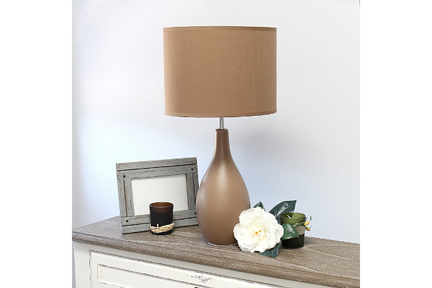 A lovely, inexpensive, and practical table lamp to meet your basic fashion lighting needs. This lamp features a ceramic oval bowling pin shaped base and matching fabric shade. Perfect for living room, bedroom, office, kids room, or college dorm!Bowling pin shaped ceramic base | Matching fabric shade | Perfect for living room, bedroom, office, kids room, or college dorm | Height: 18.11" shade diameter: 9.49"