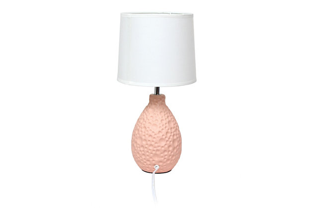 A charming and practical table lamp to meet your fashion lighting needs. This lamp features an oval textured stucco ceramic base and a white fabric shade. Perfect for living room, bedroom, office, kids room, or college dorm!Textured stucco oval ceramic base | White fabric shade | Perfect for living room, bedroom, office, kids room, or college dorm | Height: 14.17" shade diameter: 7.25"