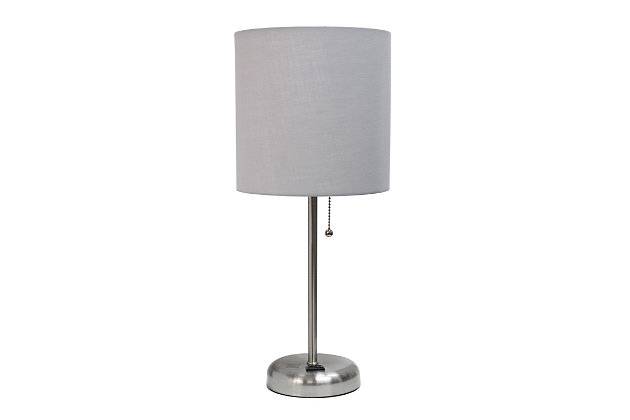 This fun and fashionable lamp features a brushed steel base and a grey fabric shade. It comes equipped with a 2 prong outlet seated in the base for use to charge mobile phones, handheld games, tablets, and other small electronics. This lamp will add a fabulous flair to any room. Perfect for bedrooms, kids and teens, college dorms, nurseries, or fun offices!Brushed steel base with charging outlet | Grey fabric shade | Perfect for bedrooms, kids room, college dorm, nursery, or fun office | Shade diameter: 8.27" x height: 19.29"