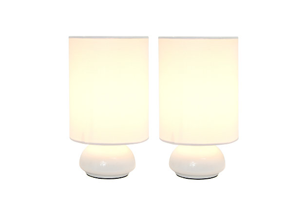 Add a contemporary feel to any room with these attractive white touch lamps. Touch controls with 4 settings (Low, Medium, High, Off). The fabric shades complete this modern look. Perfect lamp for bedroom night tables. We believe that lighting is like jewelry for your home. Our products will help to enhance your room with chic sophistication.2 x fabric shades | 2 x  mini white touch bases | 4 touch settings (high, medium, low, off) | Dimensions: height: 9" x shade diameter: 5"