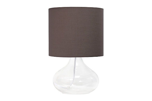 Illuminate your living space with this simple yet stylish glass table lamp.  The clear glass raindrop shaped base and gray fabric drum shade is the perfect blend  of charm to give your home a contemporary and modern upgrade.  Perfect for living rooms, bedrooms, kids and teens, college dorms, apartments, nurseries, or offices.Clear glass base | Gray fabric drum shade | Easily accessible rotary switch located on the cord | Uses 1 x 40w medium type a base bulb (not included)