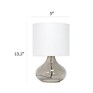 Illuminate your living space with this simple yet stylish glass table lamp.  The smoke gray glass raindrop shaped base and white fabric drum shade is the perfect blend  of charm to give your home a contemporary and modern upgrade.  Perfect for living rooms, bedrooms, kids and teens, college dorms, apartments, nurseries, or offices.Smoke gray glass base | White fabric drum shade | Easily accessible rotary switch located on the cord | Uses 1 x 40w medium type a base bulb (not included)
