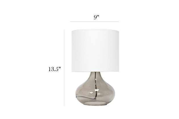 Illuminate your living space with this simple yet stylish glass table lamp.  The smoke gray glass raindrop shaped base and white fabric drum shade is the perfect blend  of charm to give your home a contemporary and modern upgrade.  Perfect for living rooms, bedrooms, kids and teens, college dorms, apartments, nurseries, or offices.Smoke gray glass base | White fabric drum shade | Easily accessible rotary switch located on the cord | Uses 1 x 40w medium type a base bulb (not included)