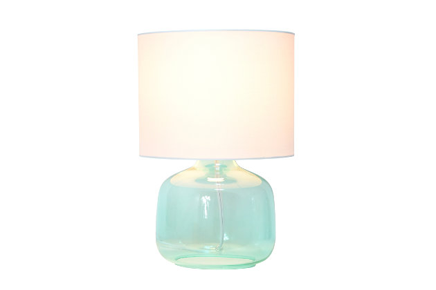 Illuminate your living space with this simple yet stylish glass table lamp. The aqua glass jar shaped base and white fabric drum shade is the perfect blend of charm to give your home a contemporary and modern upgrade. Perfect for living rooms, bedrooms, kids and teens, college dorms, apartments, nurseries, or offices.Aqua glass base | White fabric drum shade | Easily accessible rotary switch located on the cord | Uses 1 x 40w type a base bulb (not included)