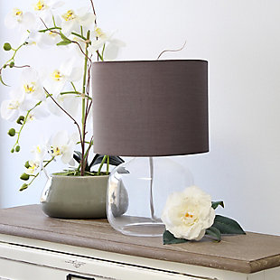 Illuminate your living space with this simple yet stylish glass table lamp.  The clear glass jar shaped base and gray fabric drum shade is the perfect blend  of charm to give your home a contemporary and modern upgrade.  Perfect for living rooms, bedrooms, kids and teens, college dorms, apartments, nurseries, or offices.Clear glass base | Gray fabric drum shade | Easily accessible rotary switch located on the cord | Uses 1 x 40w medium type a base bulb (not included)