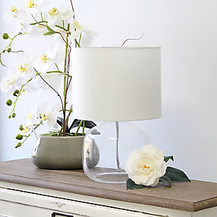 Illuminate your living space with this simple yet stylish glass table lamp.  The clear glass jar shaped base and white fabric drum shade is the perfect blend  of charm to give your home a contemporary and modern upgrade.  Perfect for living rooms, bedrooms, kids and teens, college dorms, apartments, nurseries, or offices.Clear glass base | White fabric drum shade | Easily accessible rotary switch located on the cord | Uses 1 x 40w medium type a base bulb (not included)