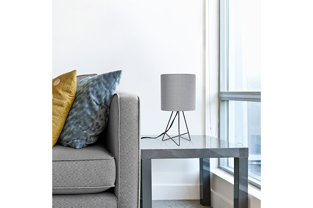Bring function and fashion to any tabletop in your home with this modern table lamp.  The gray metal base showcases an open silhouette complimented by a gray fabric drum shade.  Perfect size for any room in your home !  Illuminate your living room, bedroom, kids and teen rooms, college dorm, apartment, nursery, or offices with this modern table lamp with contemporary flair!Gray metal base | Gray fabric drum shade | Easily accessible rotary switch located on the cord | Uses 1 x 40w medium type a base bulb (not included)