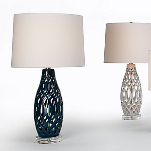 In a labyrinth of ceramic tracery, this table lamp's hollow center breathes new life into the average lamp silhouette. Its almost-woven aesthetic embraces the absence of a weighted center and instead looks light and airy. The lamp's acrylic base and white linen shade speak to its visually weightless nature.Made of ceramic with fabric shade | 3-way switch | Type E26 bulb (not included); 100 watts max; UL Listed | Clear cord | No assembly required