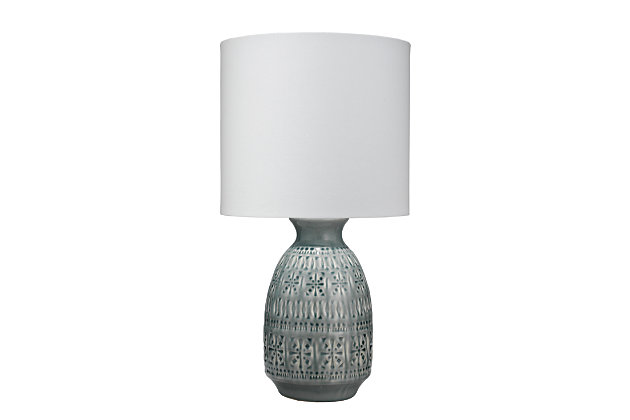 This table lamp features a delicate band of repeating patterns on ceramic clay. A simple glaze falls over the imprinted decoration and creates stunning highlights and recessions in the finish hue. Paired with a white linen lampshade, it’s the perfect addition to the bedroom, office or living room, bringing a touch of grace to your living space.Made of ceramic with fabric shade | 3-way switch | Type E26 bulb (not included); 100 watts max; UL Listed | Clear cord | No assembly required