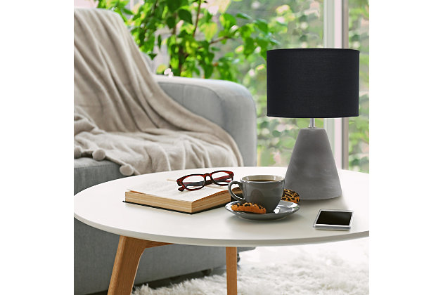 The perfect table lamp for an easy upgrade to give your home a sophisticated modern look! Simple yet stylish, this table lamp features a cone like gray concrete base complimented by a black fabric shade. Ideal for your living room, bedroom, office or entryway.Gray concrete base | Black fabric drum shade | Easily accessible rotary switch on cord | Uses 1 x 40w type b candelabra base bulb (not included) | Lamp measures l: 9" x w: 9" x h:14.20" | Sophisticated & modern
