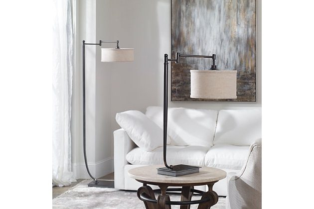 Put your contemporary decor in the best possible light with this stylish desk lamp. It features a tapered metal base finished in a plated dark bronze, and is accented by an oxidized bronze-tone foot plate with a pivoting shade arm. The suspended round drum shade is a beige linen fabric with natural slubbing. This piece illuminates your sense of style.Made of metal and fabric | Type a bulb; 100 watts max (not included) | On/off switch | Round hardback drum shade is a beige linen fabric with natural slubbing