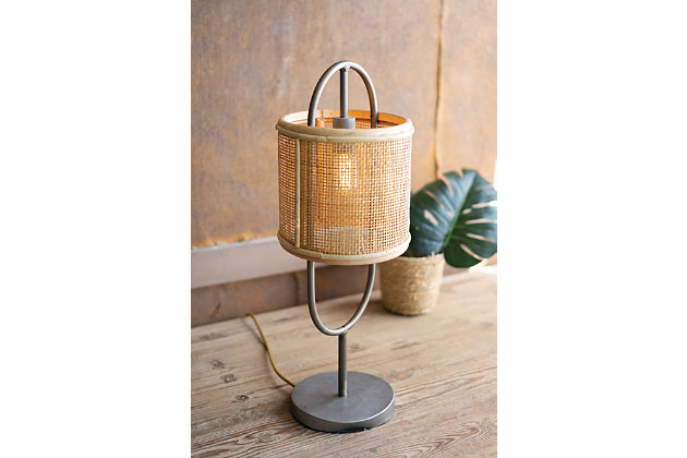 The sleek metal finish on this tabletop lamp compliments the round rattan shade and gives it a great industrial look. This is a beautiful piece that is sure to be a great addition to any space.Gunmetal finish with rattan shade | UL approved parts | Professional installation not required | Dust with dry cloth | Light bulb not included | Max of 40 Watt Bulb Recommended