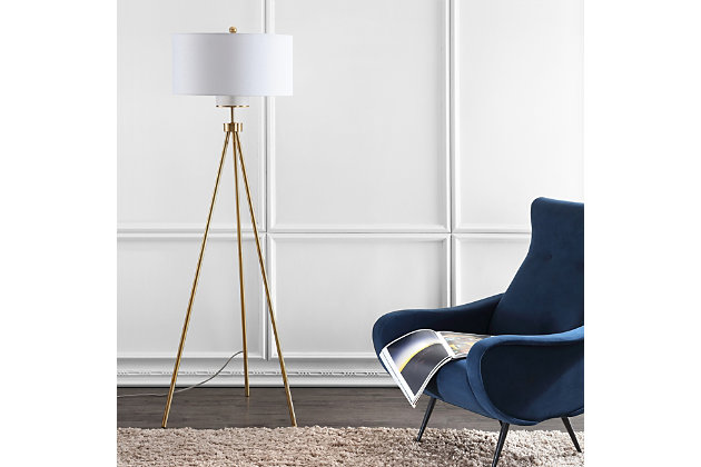 Add depth and dimension to any interior with this contemporary metal floor lamp. Its sleek tripod legs feature a radiant goldtone finish that adds opulent minimalist style to the living room or bedroom. Designers love the crisp, clean lines of its off-white shade.Goldtone finish | Tripod legs; off-white shade | Plug-in floor lamp; black cord | Includes 1 bulb: led, 9 watts | Assembly required