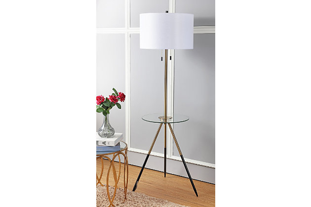 The home of Copenhagen's leading designer inspired this metal vintage-style floor lamp side table. A hybrid of illuminated luxury, its tripod legs are finished in goldtone and black, ideal for the mod living room. Designers love its two retro hanging side pulls.Tripod legs with goldtone and black finish | 2 hanging side pulls; off-white shade | Plug-in floor lamp; light gray cord | Includes 2 bulbs: led, 9 watts | Assembly required