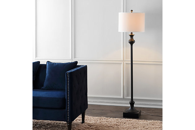 Relax and sit down for a spell. The Brewster floor lamp is ideal beside an armchair in any room in need of a warm glow and architectural detail. Its metal base, featuring an oil rubbed bronze-tone finish, boasts a weighty sculpted disposition balanced by a white drum shade.Oil rubbed bronze-tone finish on base | White drum shade | Plug-in floor lamp; light gray cord | Includes 1 bulb: LED, E26 A19, 9 watts | Assembly required