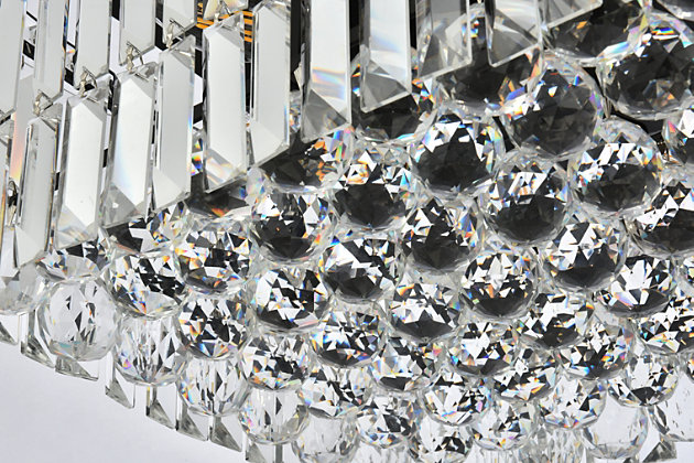 A riot of shapes and textures, Maxime collection flush mounts sparkle in a mosaic of crystal tiles. Square and rectangular precision-cut crystals form the flamboyant exterior while faceted crystal balls create a bubbled effect for light to shine through beneath. Available in a black or chrome finish with clear crystals, these lamps are a luxurious addition to a kitchen, stairwell, foyer, or living room. Warm, brilliant light is created by 16 E12 light bulbs. (not included) | Length of 28 inches, width of 14 inches, height of 7.5 inches | minimum hanging height of 14 inch and maximum hanging height of 80 inch | contrasting matte black frame finish complements the brilliant clear crystals | canopy size is 6.3 inch wide and 1 inch high | These exquisite gems will enrich the ambiance of any room, especially a kitchen, entryway, living room, or bathroom. | lighting is compatiable with LED bulbs and is dimmable; bulbs are not included