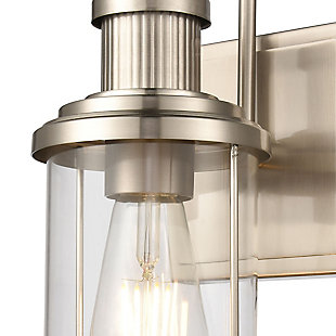 The Millburn 1-light vanity has a classic design with an oversized spun glass holder. Ideal for coastal or modern farmhouse style interiors, its subtle industrial tone adds a bit of timeless charm.  Finished in Satin Nickel with clear glass.1 Bulb Capacity | 60 Watts per bulb | Satin Nickel Finish | Compatible with LED bulb(s) | Hardwired light fixture | Rated for a damp location | Cord Length of 8 inches
