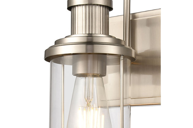 The Millburn 1-light vanity has a classic design with an oversized spun glass holder. Ideal for coastal or modern farmhouse style interiors, its subtle industrial tone adds a bit of timeless charm.  Finished in Satin Nickel with clear glass.1 Bulb Capacity | 60 Watts per bulb | Satin Nickel Finish | Compatible with LED bulb(s) | Hardwired light fixture | Rated for a damp location | Cord Length of 8 inches