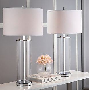 The epitome of style and substance, this clear modern glass table lamp offers world-class sophistication. Its contemporary spin on art deco style blends sleek chrome-tone detail with the clean lines of its off-white cotton shade. A modern classic.Set of 2 | Made with metal; 100% cotton shade | Includes 4 CFL bulbs | 13W max | On/off switch  | 5' cord | Assembly required | Imported