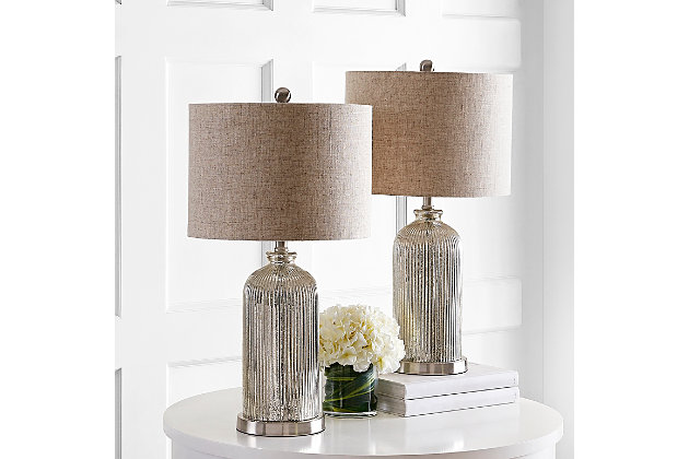 Dramatic and bold, this stylish contemporary table lamp brings rich texture to any living room. Expertly crafted with sophisticated mercury glass and a neutral beige shade, this piece blends with any decor.Set of 2 | Made with glass and iron; 100% cotton shade | Includes 2 led a19 9w bulbs | Max. Wattage: 100w (type "a"), 23w (cfl), 12w (led) | On/off switch | 5' cord | Assembly required | Imported