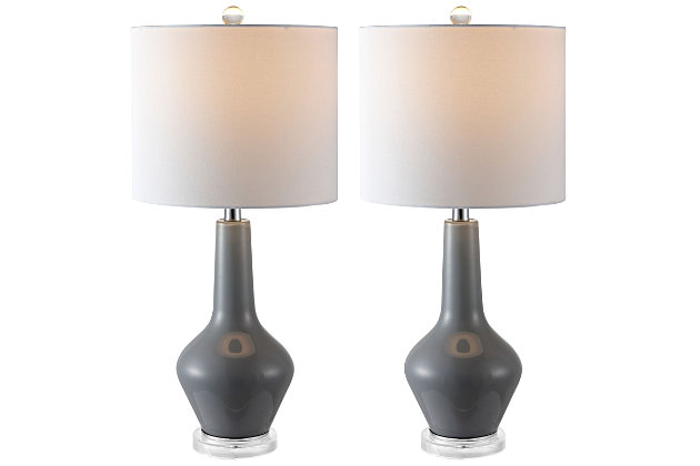 Upgrade any living room or bedroom with the clean modern curves of this contemporary table lamp. Crafted with sleek smoked gray glass to illuminate its exquisite form, it sits on a clear acrylic base and is topped with a complementary white drum shade.Set of 2 | Made with glass and metal; 100% cotton shade | Includes 2 led a19 9w bulbs | Max. Wattage: 60w (type "a"), 13w (cfl), 9w (led) | On/off switch | 5' cord | Assembly required | Imported