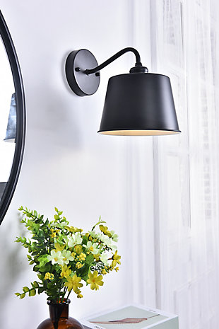 The Nota Collection wall lamp creates a melody of illumination that will shine brilliantly. Like a single whole note played with certainty and purpose, this single wall light will bring a purposeful, beautiful light to any home large or small.Made of metal | Contemporary and minimalistic wall sconce in a black finish with drum-shaped shade and gentle curving arm | Uses E26 bulb (sold separately) | Drum-shaped metal shade with white interior | Circular backplate | Wall sconce extension: 10.8" | Dimmable | Assembly required | Imported
