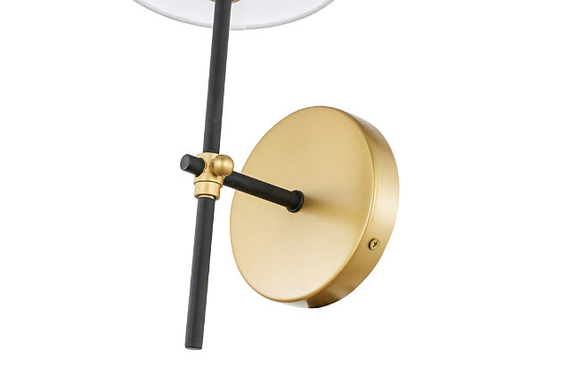 This wall lamp in the Mel Collection adds refined simplicity to your life. With an unassuming design, this versatile lamp blends in with any decor, while the sleek rod and clean linen shade add contemporary elegance and style. It brings a breath of fresh air, and is the perfect addition to your bathroom or entryway.Made of metal and fabric | Timeless design with clean lines and sleek minimalism | White linen shade | 1 light illuminates upward | Easily mounted on wall | Uses e12 bulb (sold separately); compatible with led bulbs | Dimmable | No assembly required | Imported