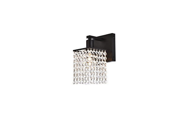 This Phineas Collection sconce exudes elegance and sparkling beauty. Why wouldn't it, with its beautiful curtain of clear crystal strands that shimmer with each passing second as light passes through? Your home will be illuminated and your guests will be charmed by these dancing crystal lights. And you'll be pleased with how this wall lamp can elevate any room into a luxurious and glamourous world.Made of crystal and iron | Glamourous and ritzy wall sconce sparkles with cool ease | Curtains of clear crystals | Light illuminates downwards (and is dimmable) | Uses E12 bulb (sold separately); compatible with LED bulbs | Easily mounted on wall | No assembly required | Imported